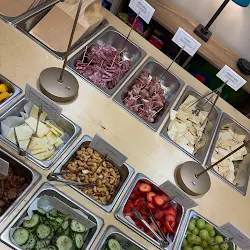 Grazing trays with labeled charcuterie, fruit, and artisan crackers for Teacher Appreciation Week